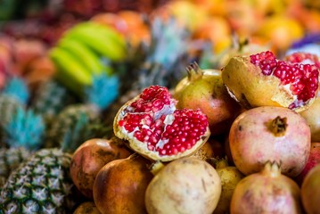 selective focus on pomegranate and other fruits in morocco