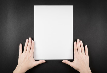 Female hands frame shape holding blank A4 copy space letter on black background