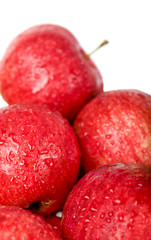 Ripe red apples with drops of water isolated on white