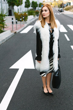 Attractive Redhead Woman Standing in a Road