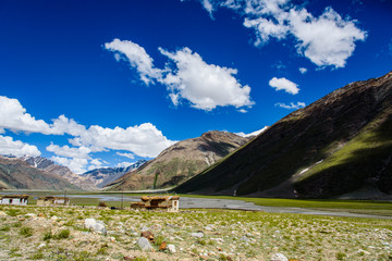 Fototapeta premium Landscape of small house and grass field with blue sky, India
