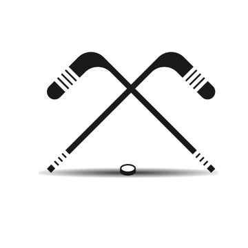 Vector icon hockey sticks and a puck with shadow