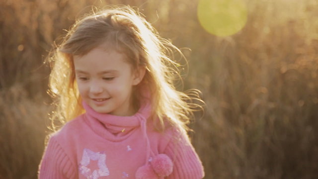 happy little girl in the sunset light