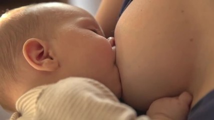 Mother breast feeding her baby - Powered by Adobe