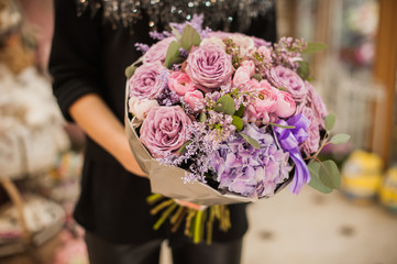  womans hand holding a bouquet of flowers