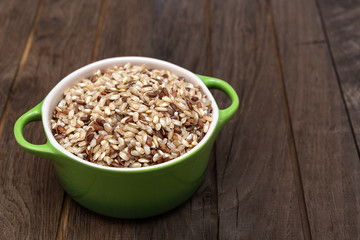 Raw brown rice in ceramic pot