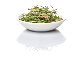 Fresh rosemary herbs in white bowl over white background