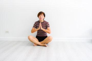 Fototapeta premium Smart Asian woman meditating indoors at home.