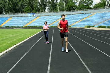 Young people jogging on stadium