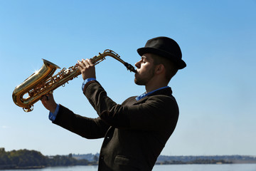Saxophonist plays on the pier