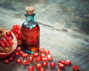 Pomegranate juice or tincture and garnet fruit with seeds on kit