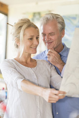 mature couple while painting on a canvas