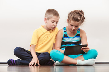 Children playing on tablet.