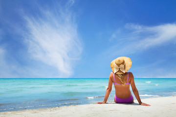 woman sitting on paradise beach