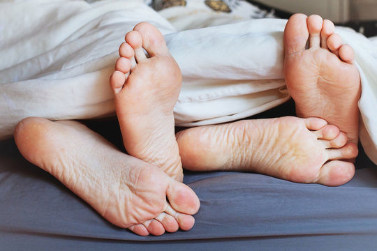 feet of family under blanket, happy morning of loving couple