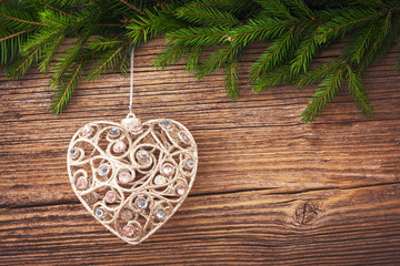 Christmas background. Christmas fir tree with Christmas tree toy on old wooden board background with copy space. Toned