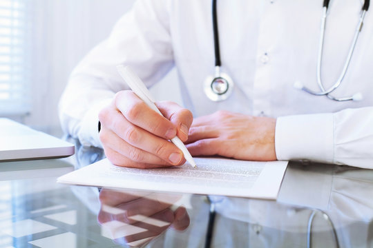 Medical Diagnose, Hands Of Doctor Writing In Clinical Record