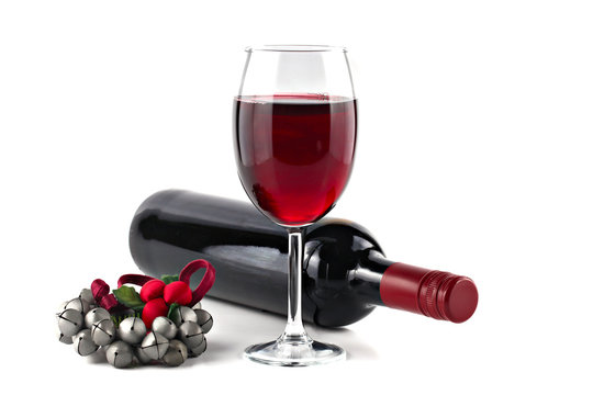 Red wine with Christmas ornament isolated on white background, s