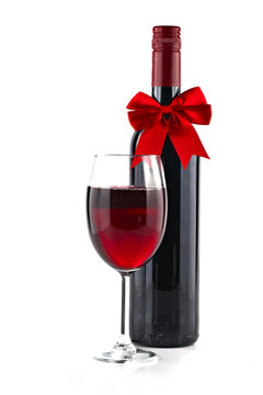 Red wine with Christmas ribbon isolated on white background, sha