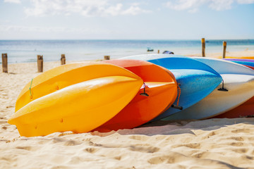 Row of colorful kayaks at sea shore on Tangalooma Island, Queensland.