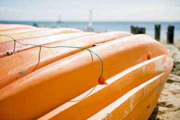 Row of colorful kayaks at sea shore on Tangalooma Island, Queensland.
