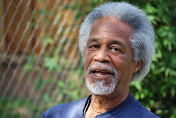 African american male relaxing outdoors in his backyard.