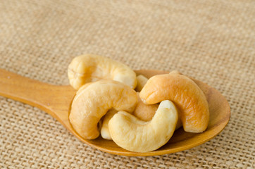 Cashew in wooden spoon.