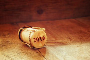 Champagne corks with 2016 year stamp over wooden table. retro style image
