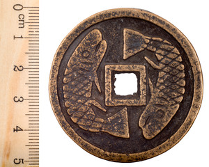 Most ancient Chinese copper coin with a hole. Shang dynasty. Obverse. Isolated on white © sytilin