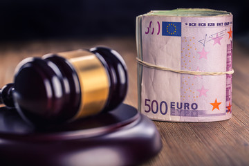 Judge's hammer gavel. Justice and euro money. Euro currency. Court gavel and rolled Euro banknotes....