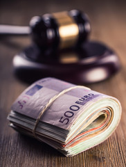 Judge's hammer gavel. Justice and euro money. Euro currency. Court gavel and rolled Euro banknotes. Representation of corruption and bribery in the judiciary.