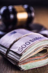 Judge's hammer gavel. Justice and euro money. Euro currency. Court gavel and rolled Euro banknotes....
