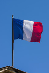 Fototapeta na wymiar French flag against blue cloudy sky