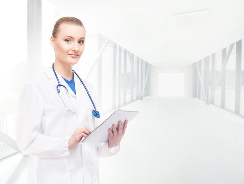 Young, professional and cheerful female doctor in hospital corri