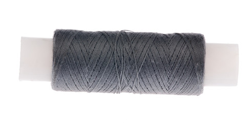 spool of grey thread isolated on white