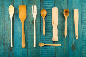 kitchen utensils on wooden background. spoon, mortar, kitchen spatula, rolling pin