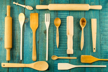 kitchen utensils on wooden background. spoon, mortar, kitchen spatula, rolling pin