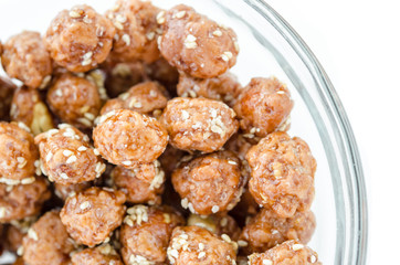 Honey roasted coated peanuts and white sesame seeds.