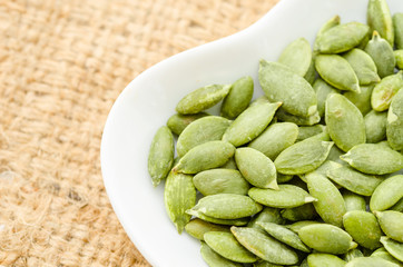 Raw Organic Pumpkin Pepita Seeds in a Bowl.