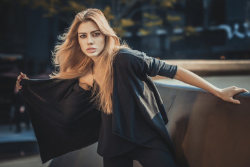 Beautiful young model woman posing in modern architecture environment