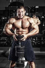 Fototapeta na wymiar Bodybuilder muscle Athlete training with weight in gym