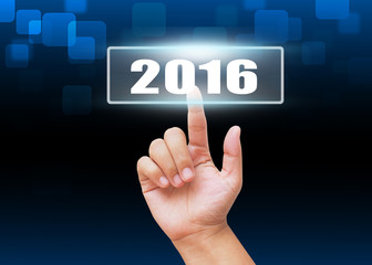 Hand pressing 2016 button with technology background 