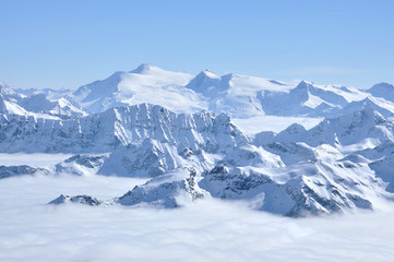 Fototapeta na wymiar Alpine snow covered peak in the Alps at winter