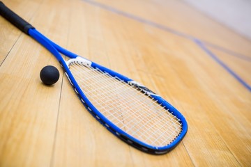 Close up of a squash racket and ball