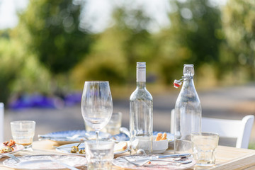 Food table after dinner on a wooden table with white chair