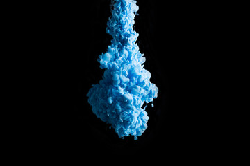 Blue ink in water on a black background.