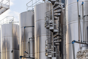 Metal wine barrels at a winery aligned in row