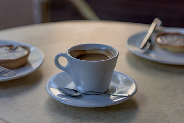 White cup of coffee at a restaurant table