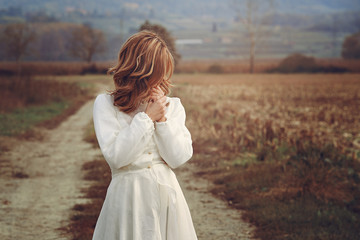 Romantic woman with vintage bride dress