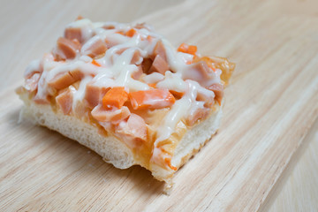 piece of pizza topping with ham and cheese